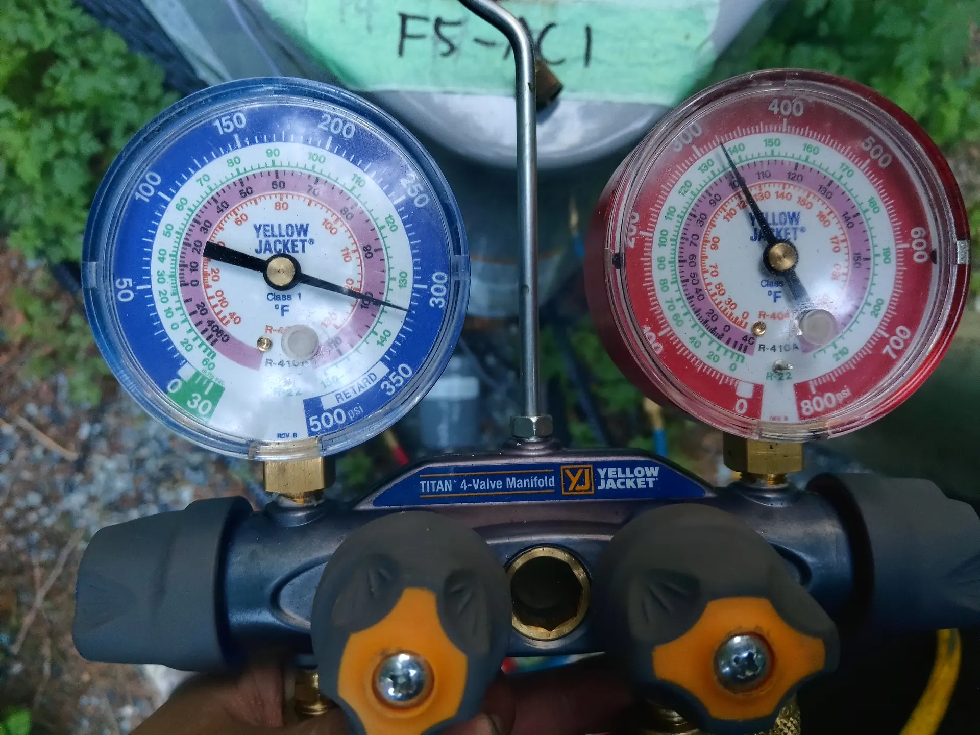 HVAC technician using professional manifold gauge diagnostic tools